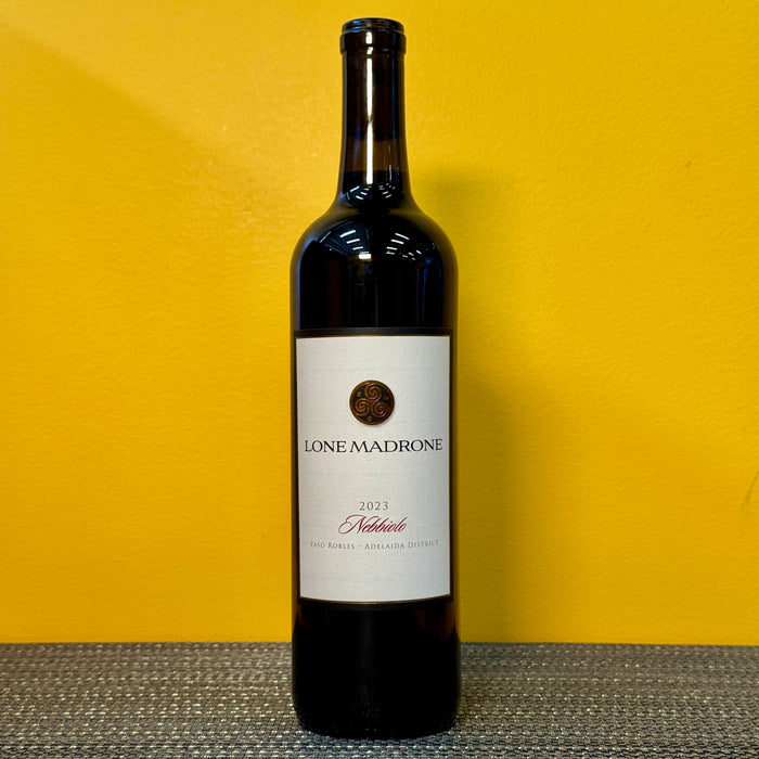 Wine bottle labeled 'Lone Madrone Nebbiolo' on a yellow background